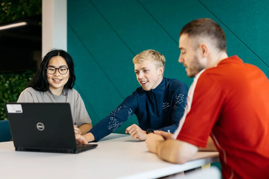 students working together looking at a laptop
