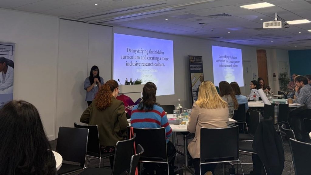 People sat round tables watching the presentation